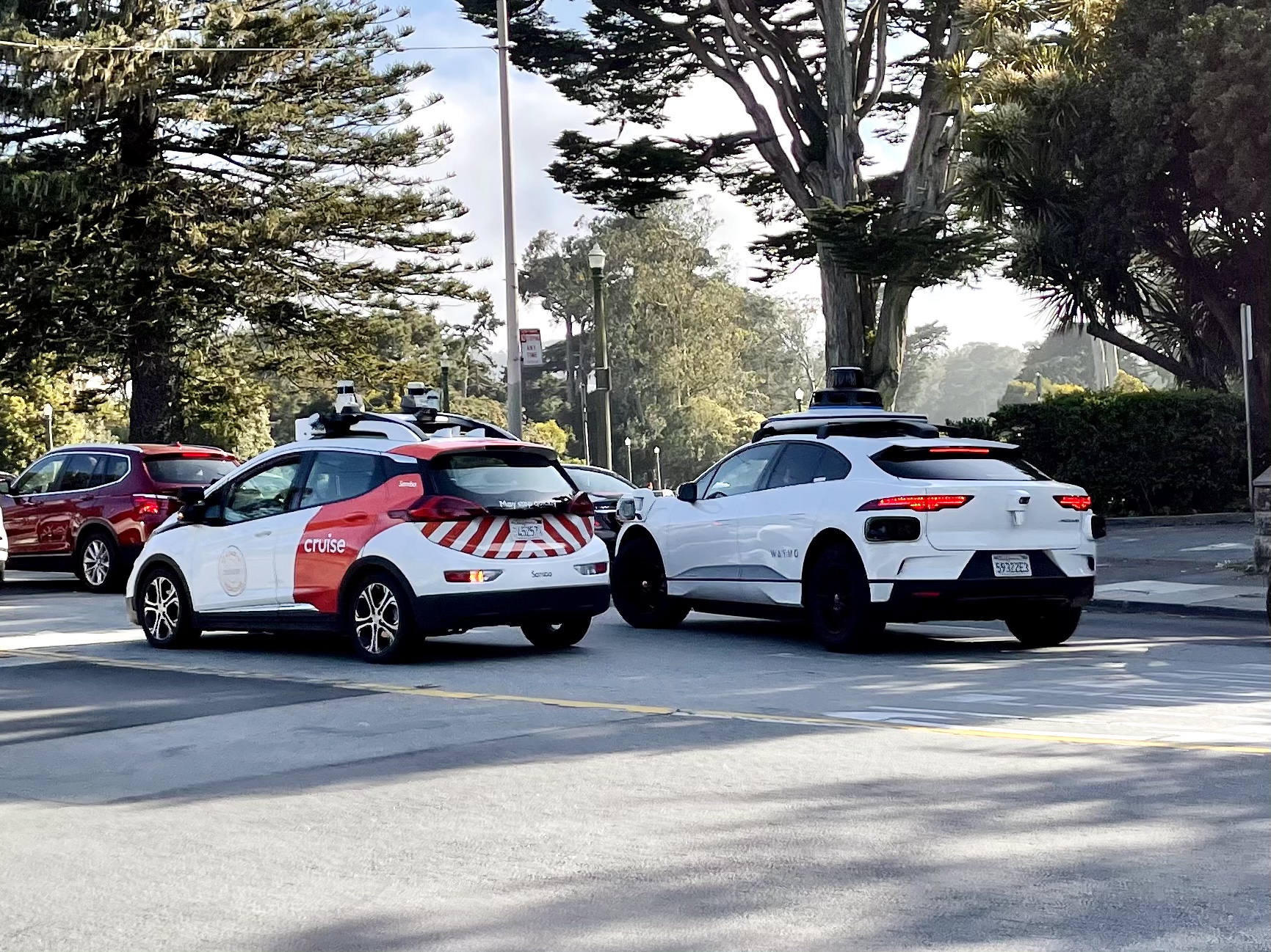 A Cruise and a Waymo side-by-side near Golden Gate Park.